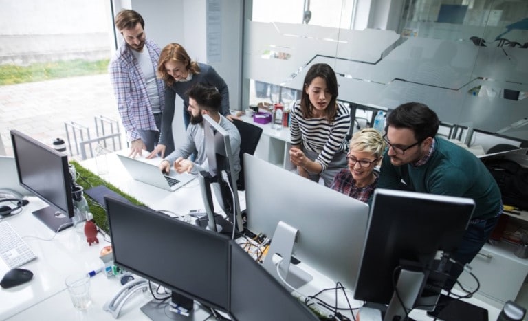 Digital transformation of work. Team working in office iwth computers.